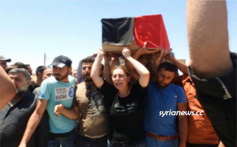 Mother of Syrian Journalist Martyr Khalid Al Khatib carrying his coffin